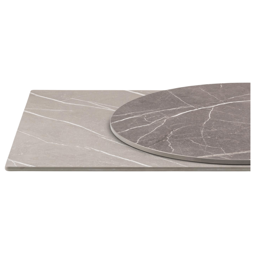 Combination of round and rectangular full-core table tops in soft marble look. Natural tones with white veins, suitable for stylish hospitality interior design.