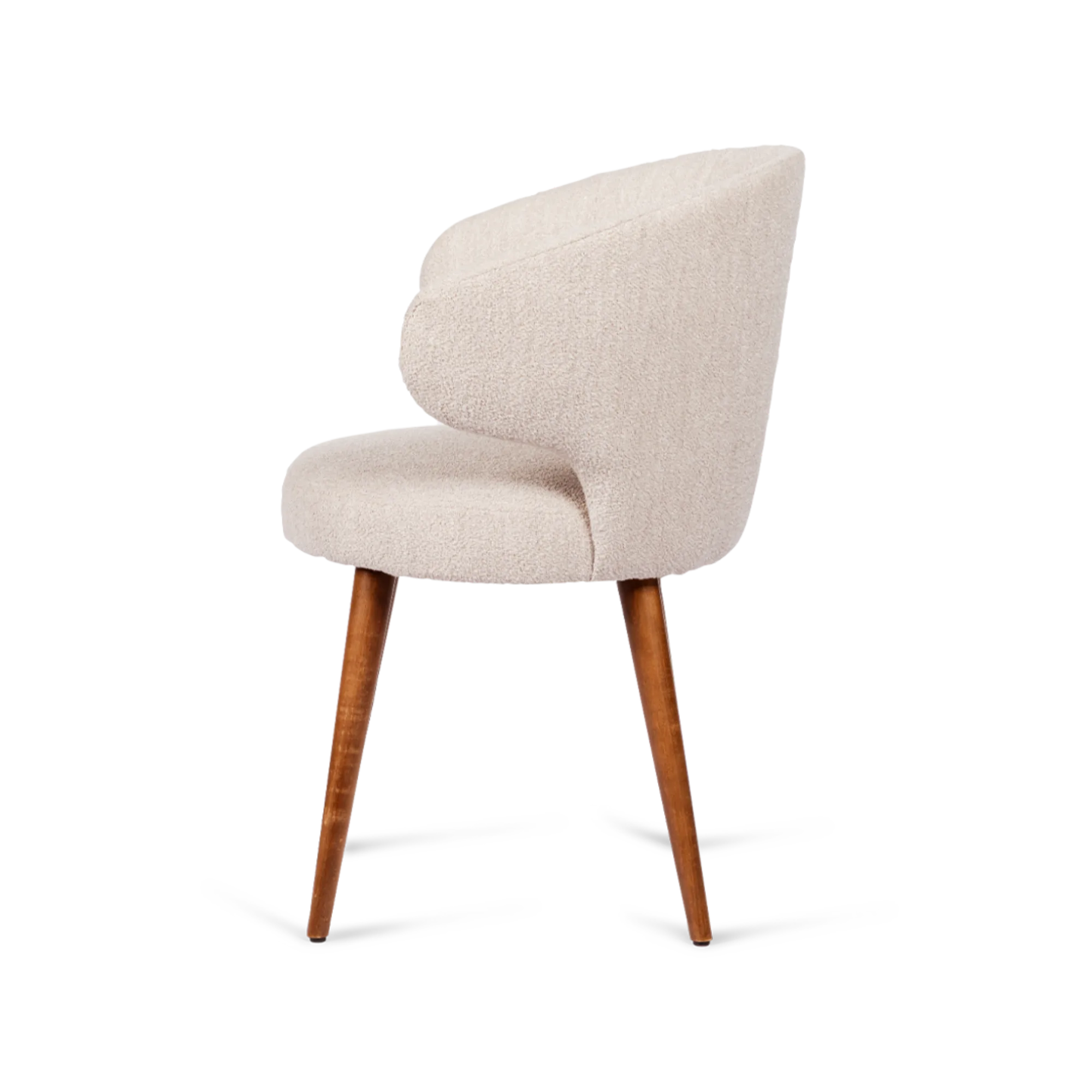Chicca dining chair with soft upholstery, a rounded backrest, and sturdy wooden legs