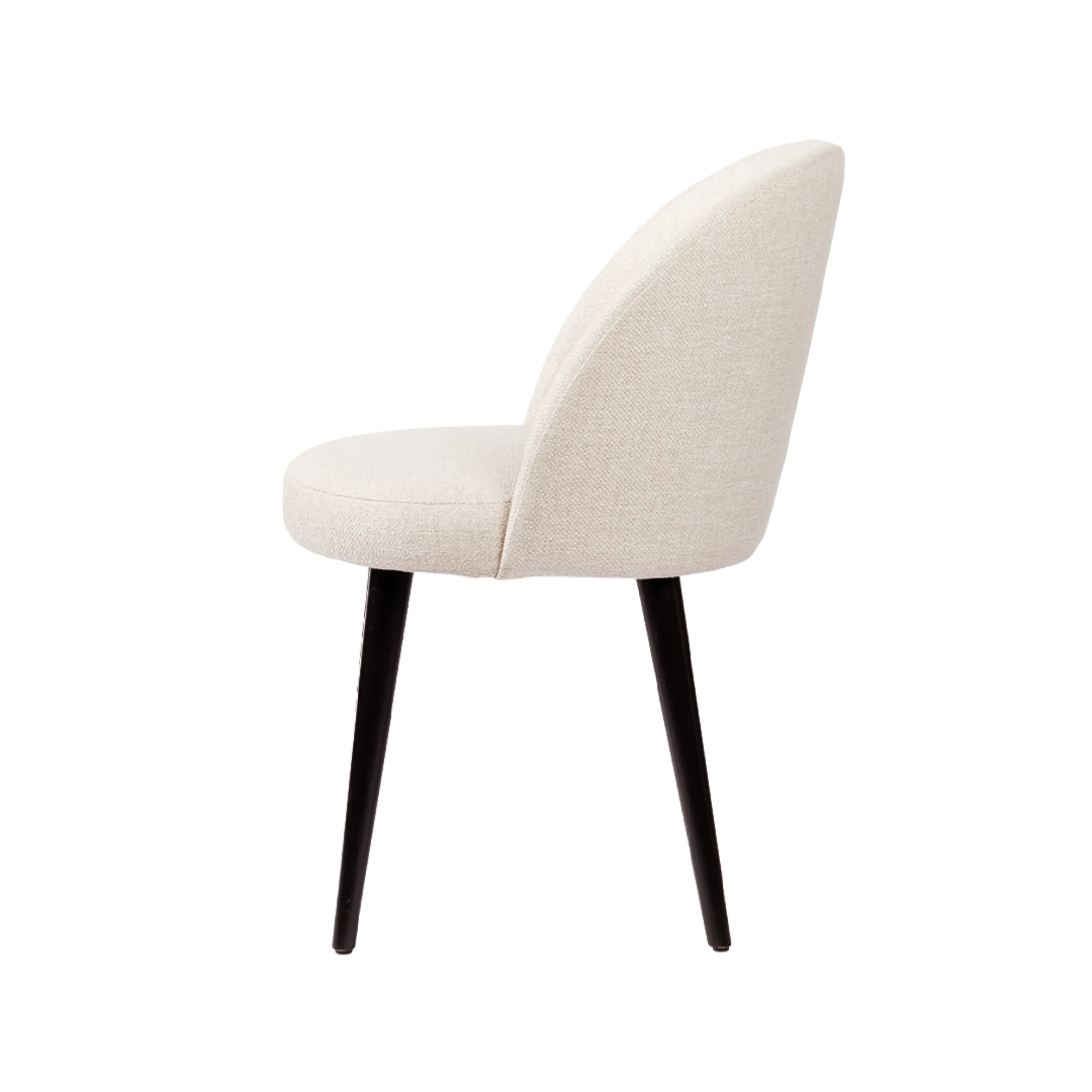 Side view of the Kate chair with soft, light-colored upholstery, a curved backrest, and slender dark legs.